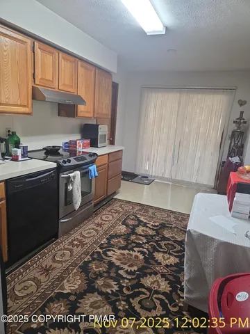 a kitchen with a stove a sink and a refrigerator