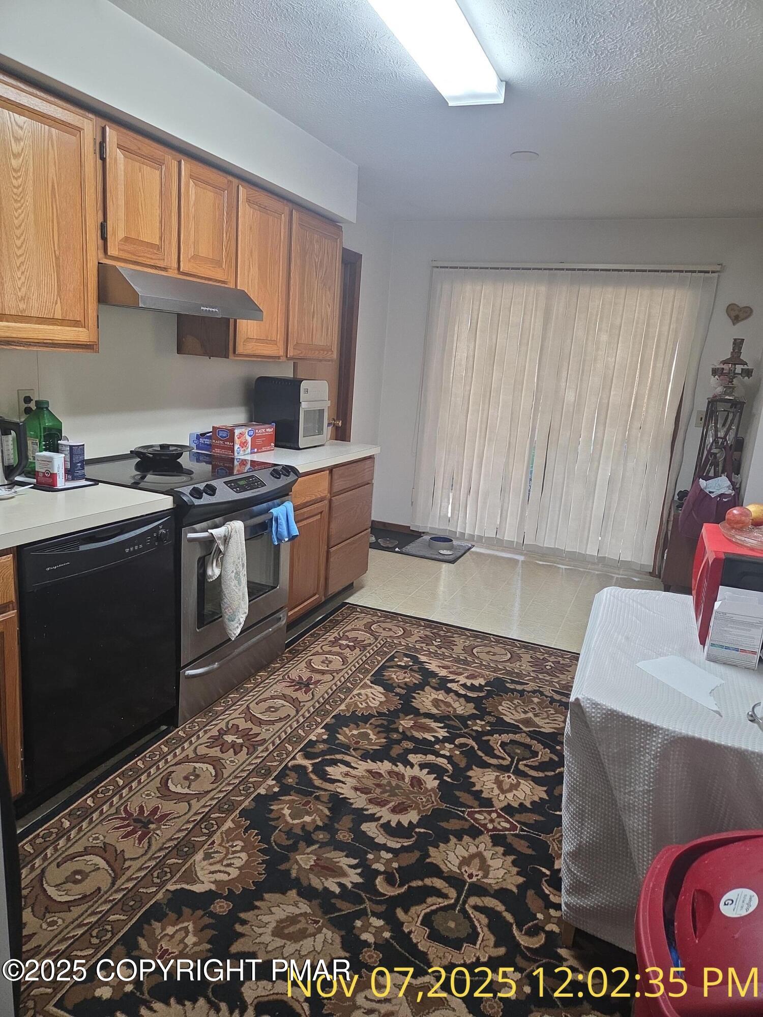 1107 Hampstead Road Bushkill, PA 18324 - Photo 13 of 20 a kitchen with a stove a sink and a refrigerator