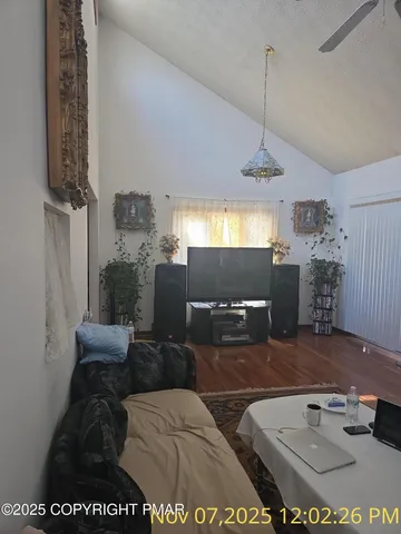 a living room with furniture and a chandelier