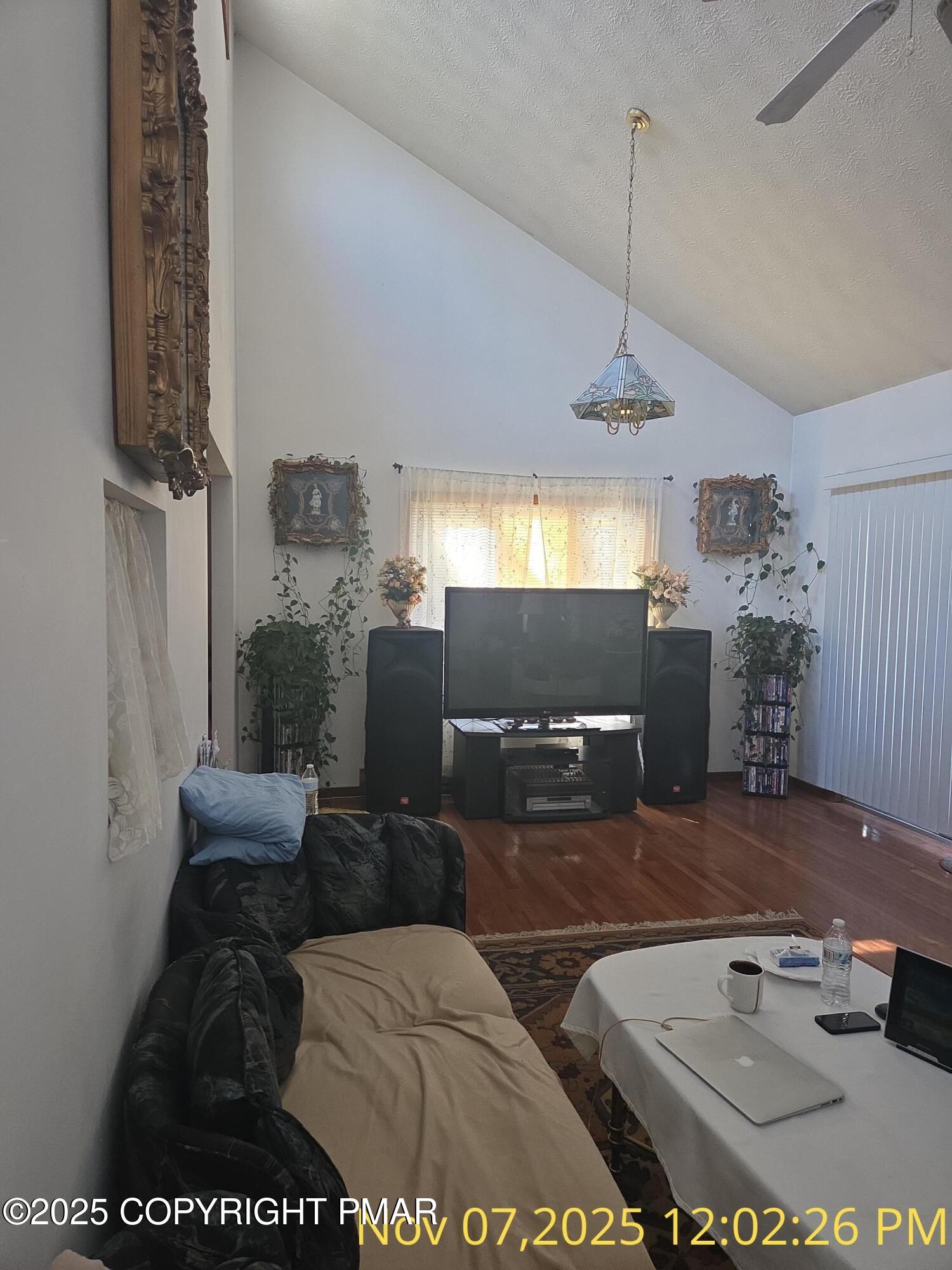 1107 Hampstead Road Bushkill, PA 18324 - Photo 14 of 20 a living room with furniture and a chandelier