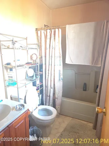 a bathroom with a toilet a sink and a window