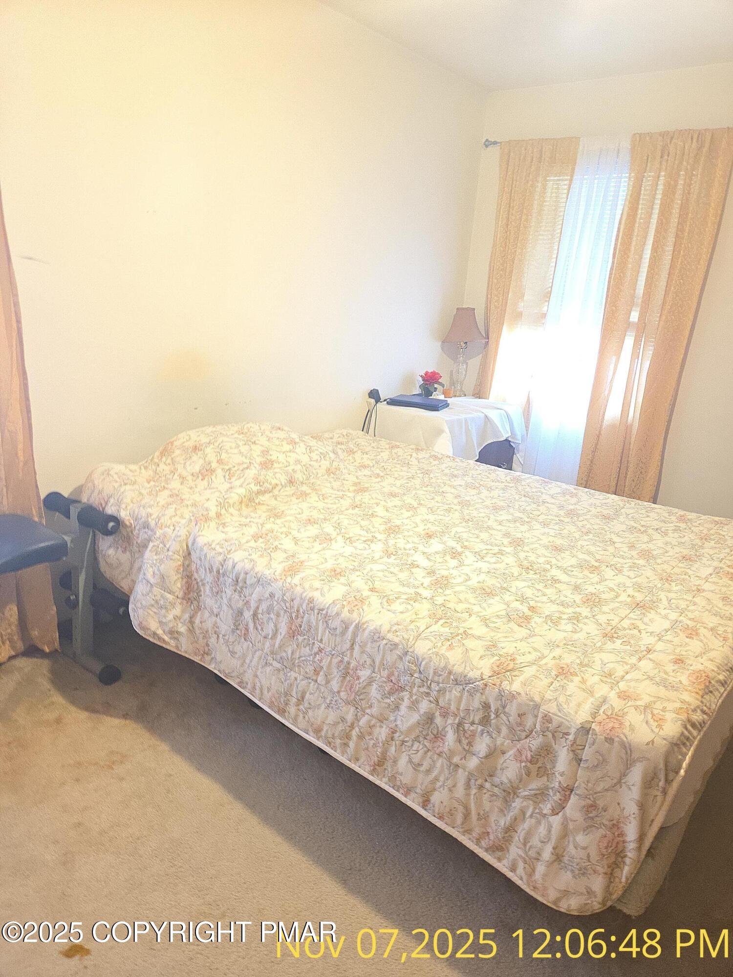 1107 Hampstead Road Bushkill, PA 18324 - Photo 4 of 20 a bed sitting in a bedroom next to a window