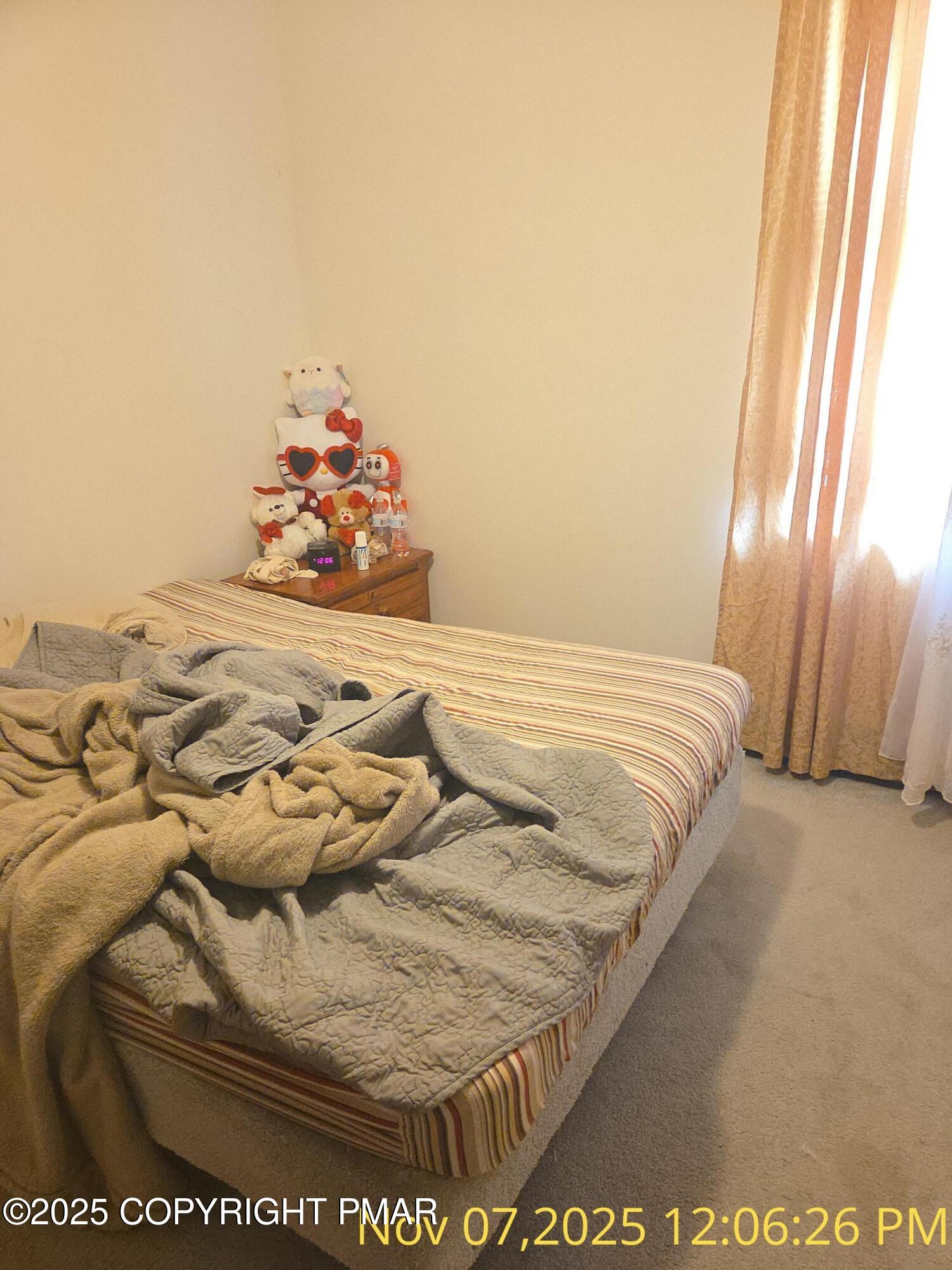 1107 Hampstead Road Bushkill, PA 18324 - Photo 5 of 20 a bed sitting in a bedroom next to a window