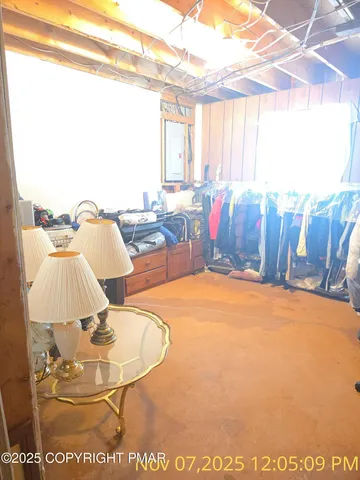 a view of a living room with furniture and a window