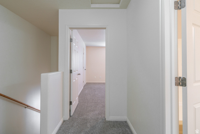 1735 West 540 North, Unit 1805 St. George, UT 84770 - Photo 41 of 64 Hallway featuring light-colored walls, gray carpet flooring, and white trim