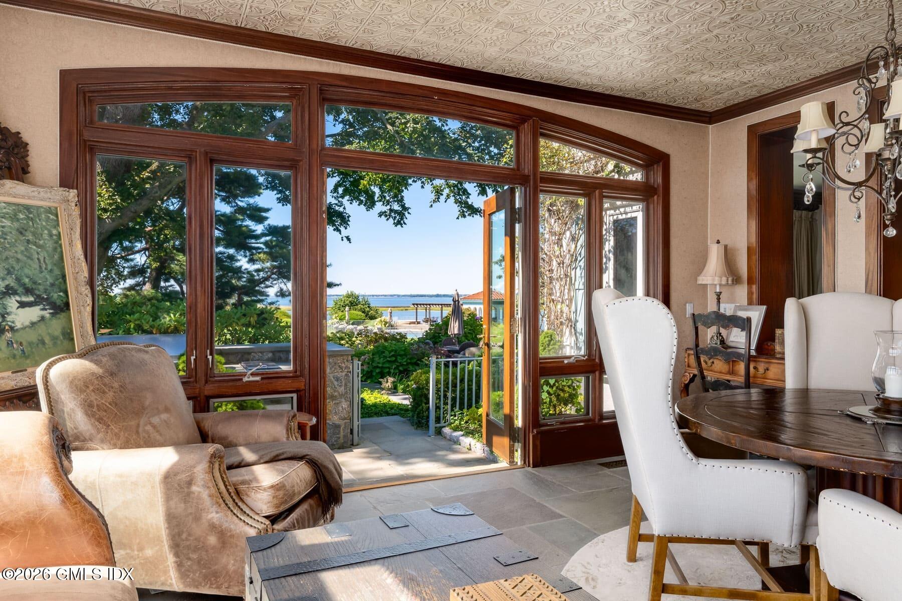 108 Cedar Cliff Road Riverside, CT 06878 - Photo 26 of 49 a view of a dining room with furniture large windows and wooden floor