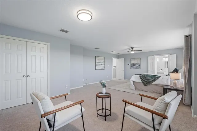 a bedroom with a bed and a ceiling fan