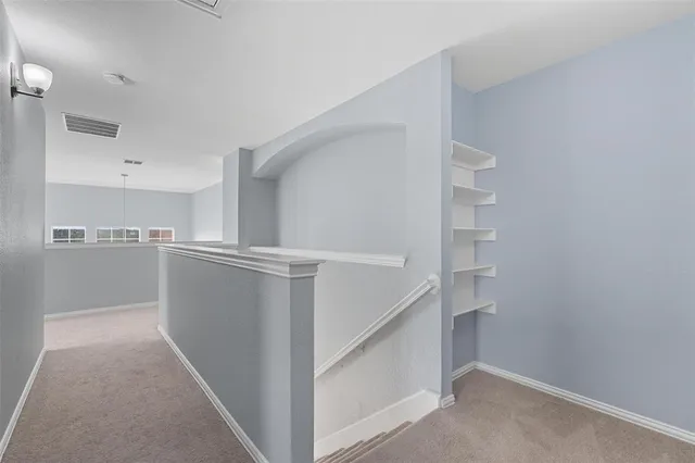 a view of an empty room and a window