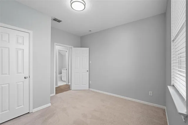 a bathroom with a granite countertop toilet sink and mirror