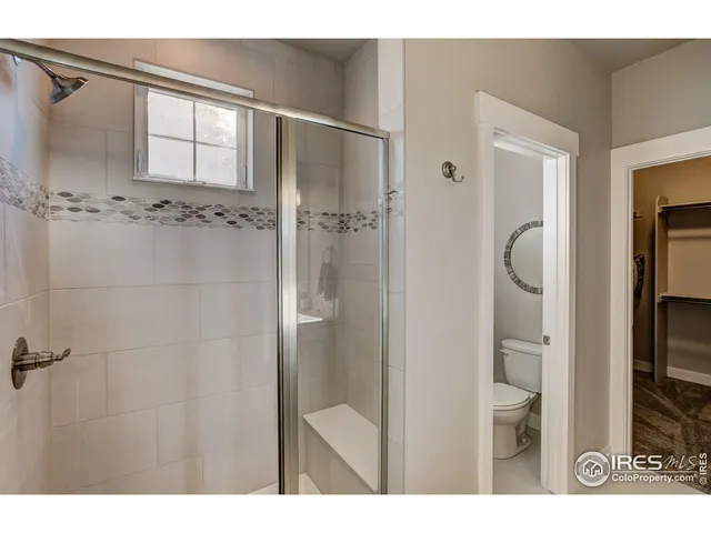 a bathroom with a shower and a bathroom