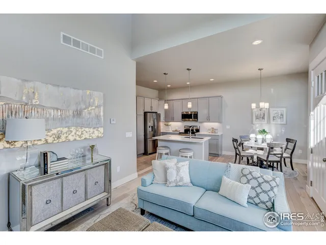 a living room with kitchen island furniture and kitchen view