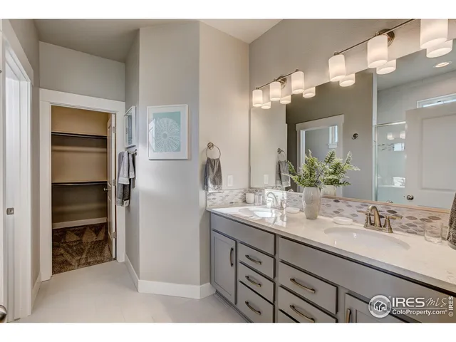 a bathroom with a sink double vanity and a mirror