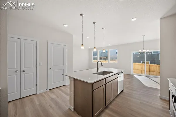 a kitchen with stainless steel appliances a sink stove and cabinets