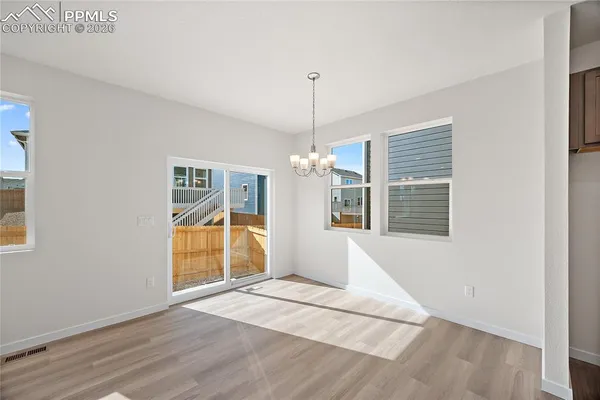 a large kitchen with kitchen island a stove a sink a center island and wooden floor