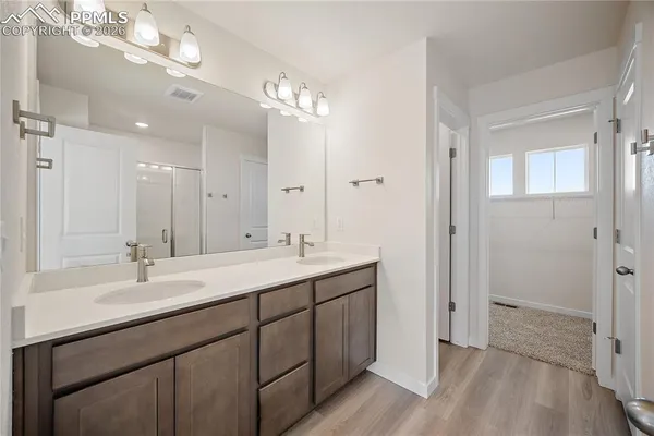 a bathroom with a shower and a glass door
