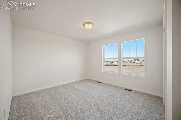 a view of an empty room and a window