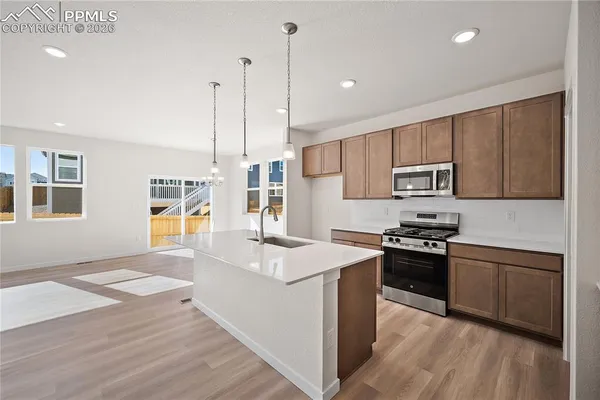 a kitchen with sink cabinets and wooden floor