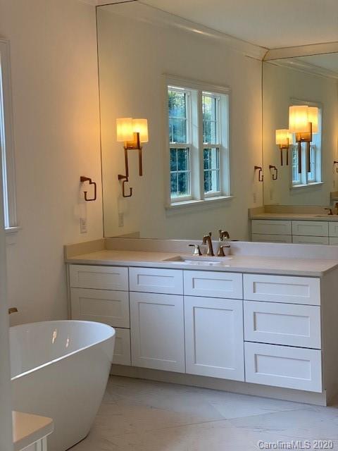 2811 Sharon Road Charlotte, NC 28211 - Photo 2 of 13 a bathroom with a tub a sink and mirror