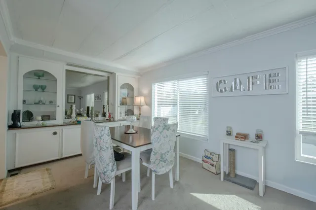 a dining room with furniture and window