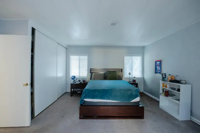 a bedroom with a bed and a window