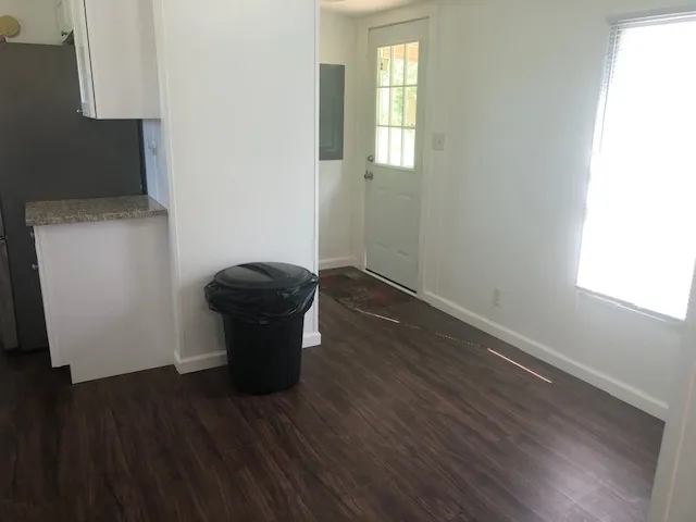 a kitchen with granite countertop white cabinets and stainless steel appliances