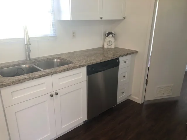 a view of a kitchen from a hallway