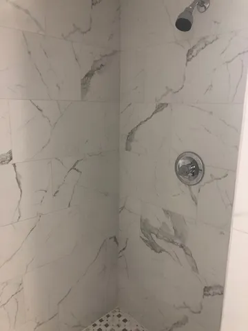 a kitchen with wooden floor and a window