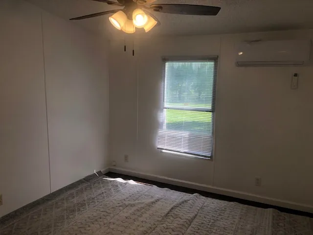 a bathroom with a granite countertop bathtub shower sink and toilet