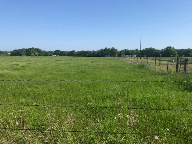 a view of a house with backyard and deck