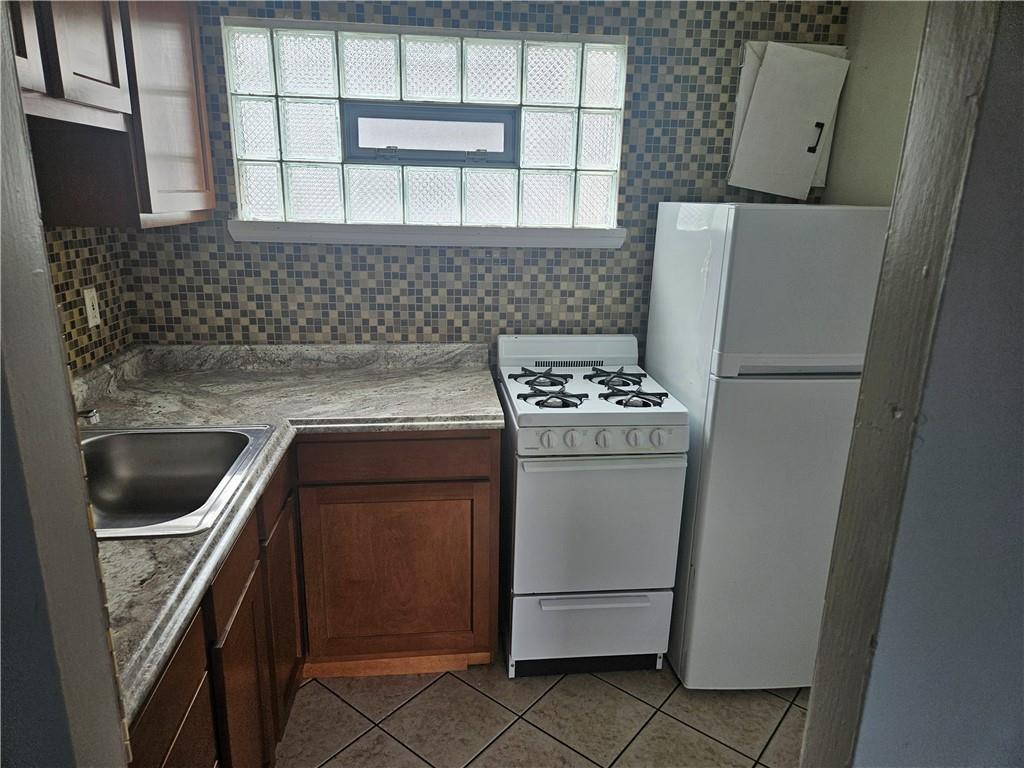1905 Hanover Street, Unit 7 Pittsburgh, PA 15218 - Photo 7 of 22 a kitchen with a refrigerator sink and stove