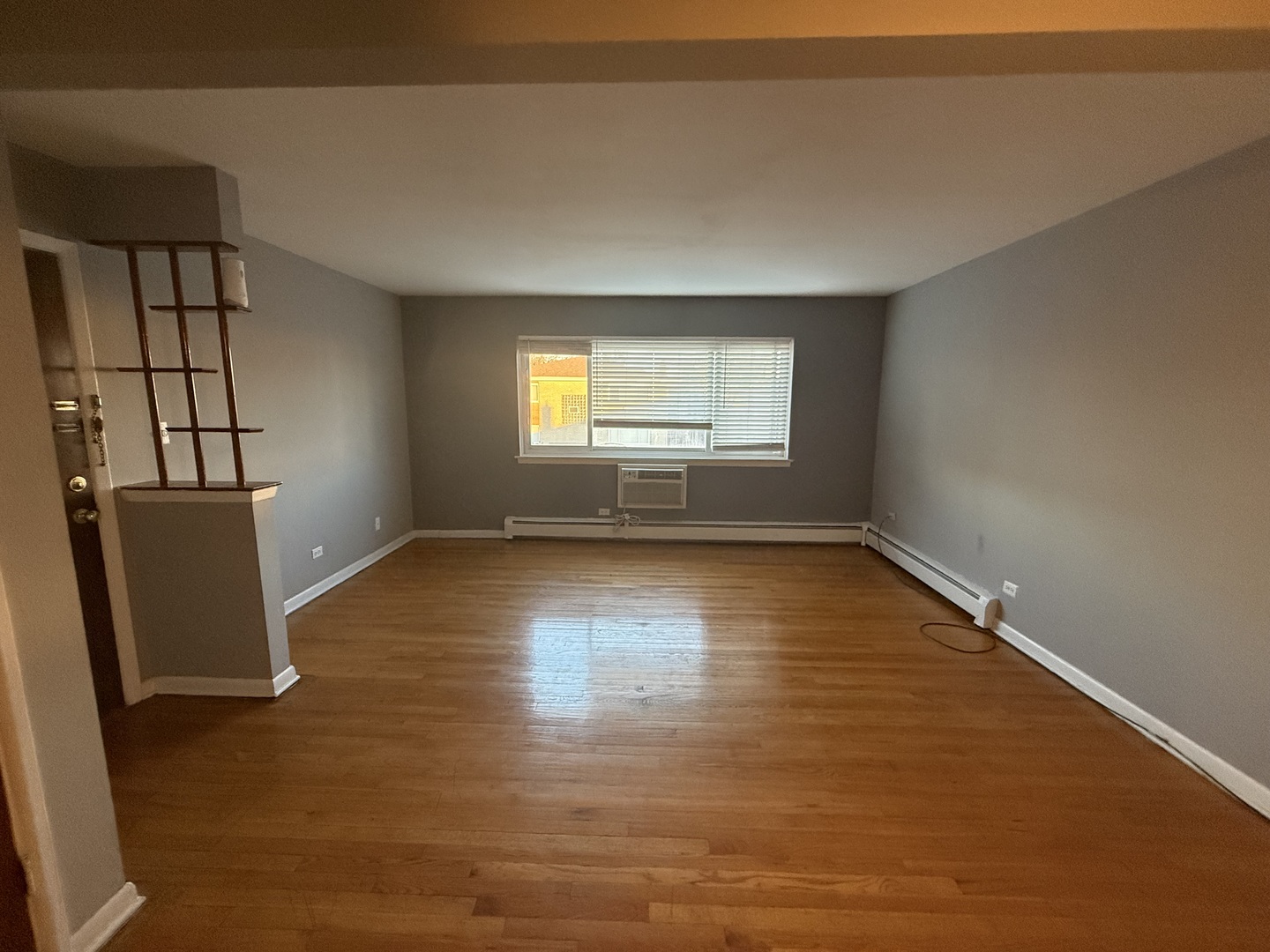 9575 Maple Drive, Unit 2S Rosemont, IL 60018 - Photo 3 of 12 wooden floor in an empty room with a window