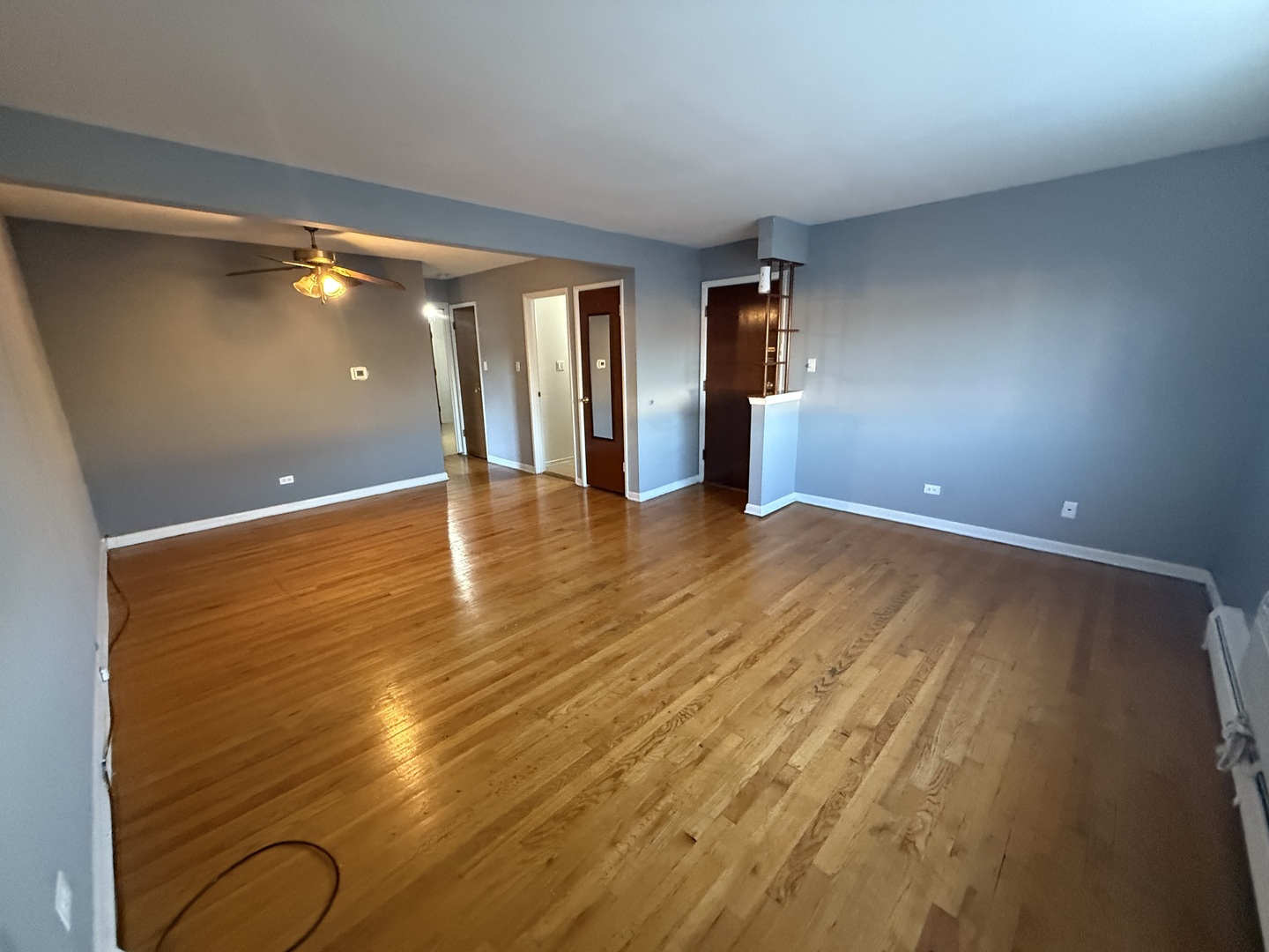 9575 Maple Drive, Unit 2S Rosemont, IL 60018 - Photo 5 of 12 a view of an empty room with window and wooden floor