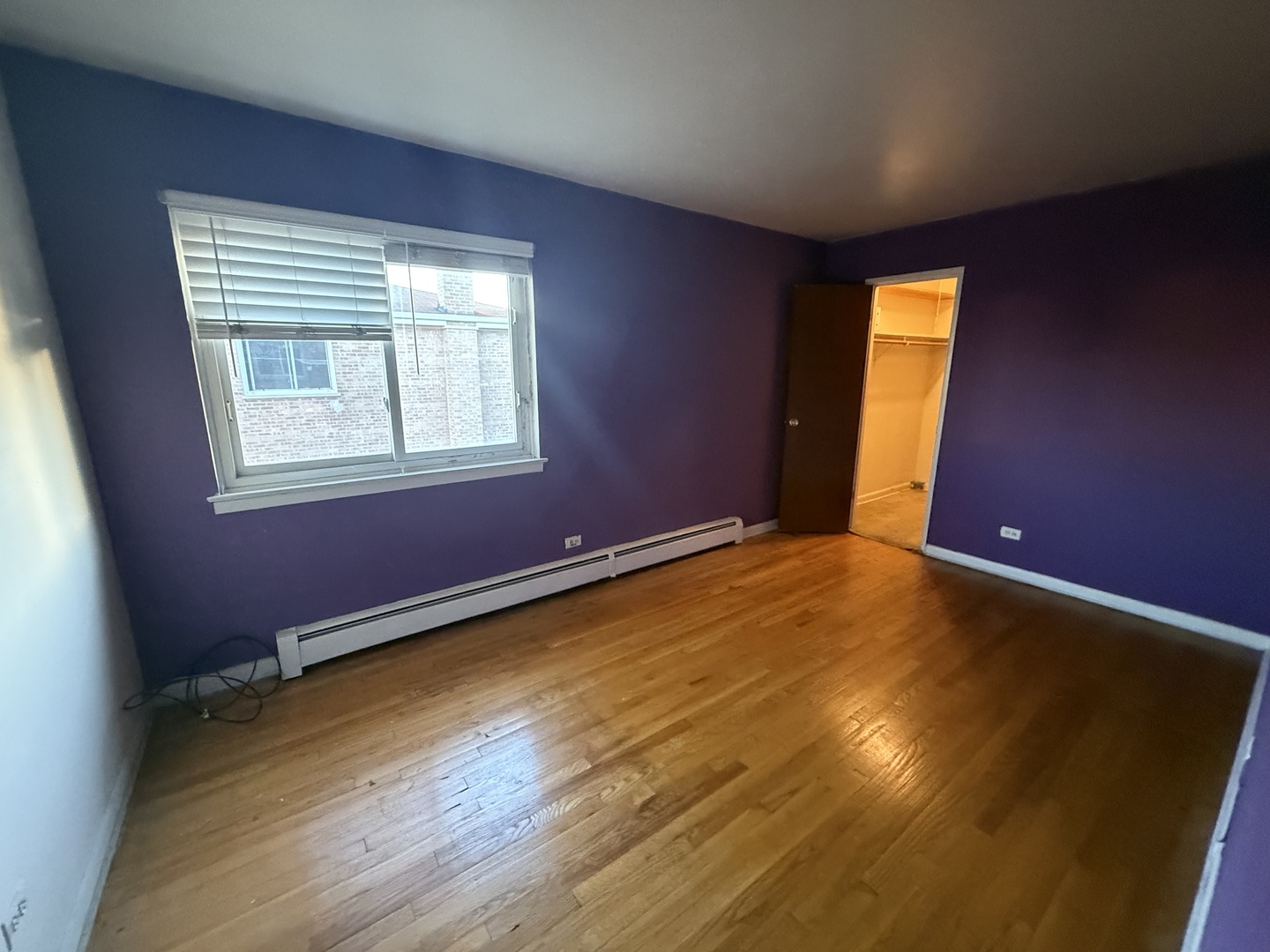 9575 Maple Drive, Unit 2S Rosemont, IL 60018 - Photo 8 of 12 a view of an empty room with wooden floor and a window