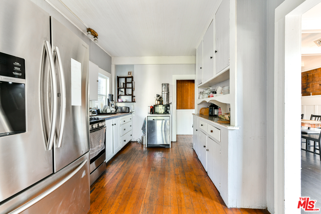 53 Dudley Avenue Venice, CA 90291 - Photo 11 of 28 a kitchen with white cabinets and stainless steel appliances