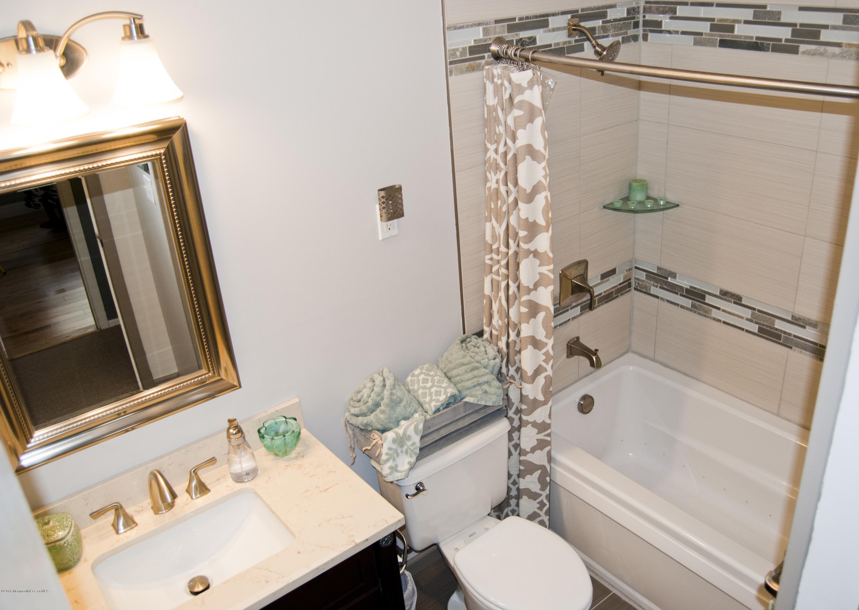 439 Line Road Aberdeen, NJ 07747 - Photo 14 of 22 a bathroom with a sink toilet and shower