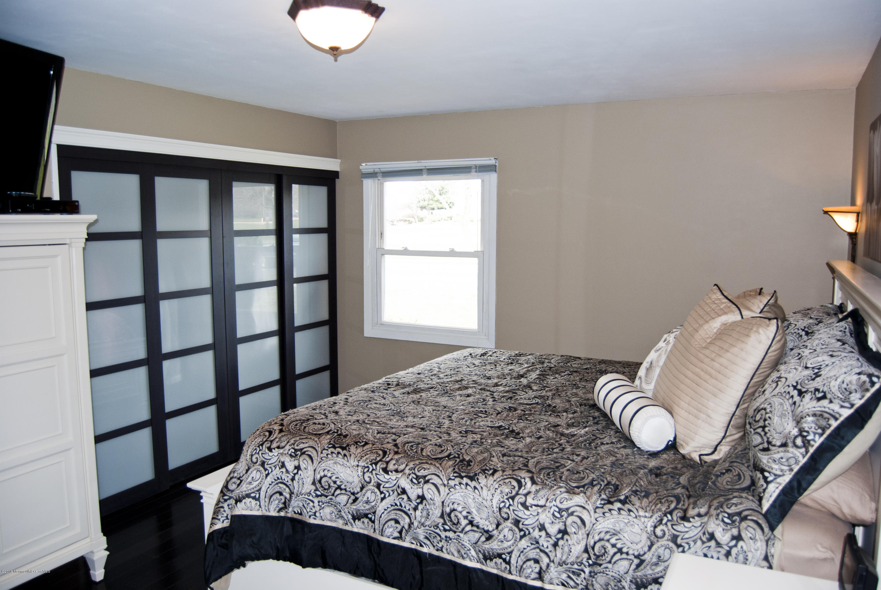 439 Line Road Aberdeen, NJ 07747 - Photo 9 of 22 a bedroom with a bed and a flat screen tv
