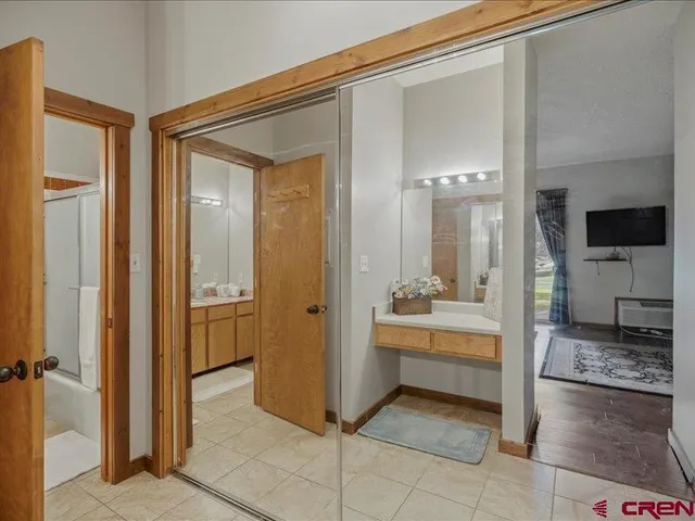 a bathroom with a glass door shower a sink and a mirror