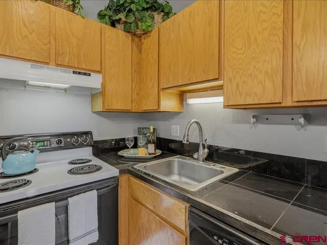 a kitchen with a sink stove and cabinets