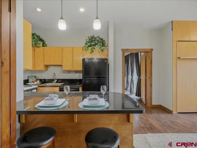 a kitchen with sink a refrigerator and microwave