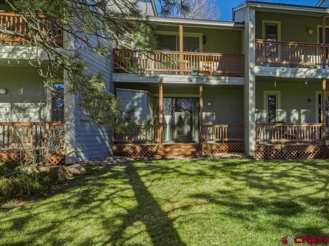 a view of a house with a yard porch and sitting area