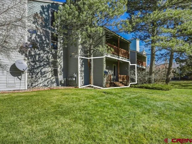 a view of a house with backyard and sitting area