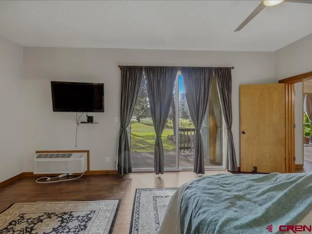 a bedroom with a bed and large window