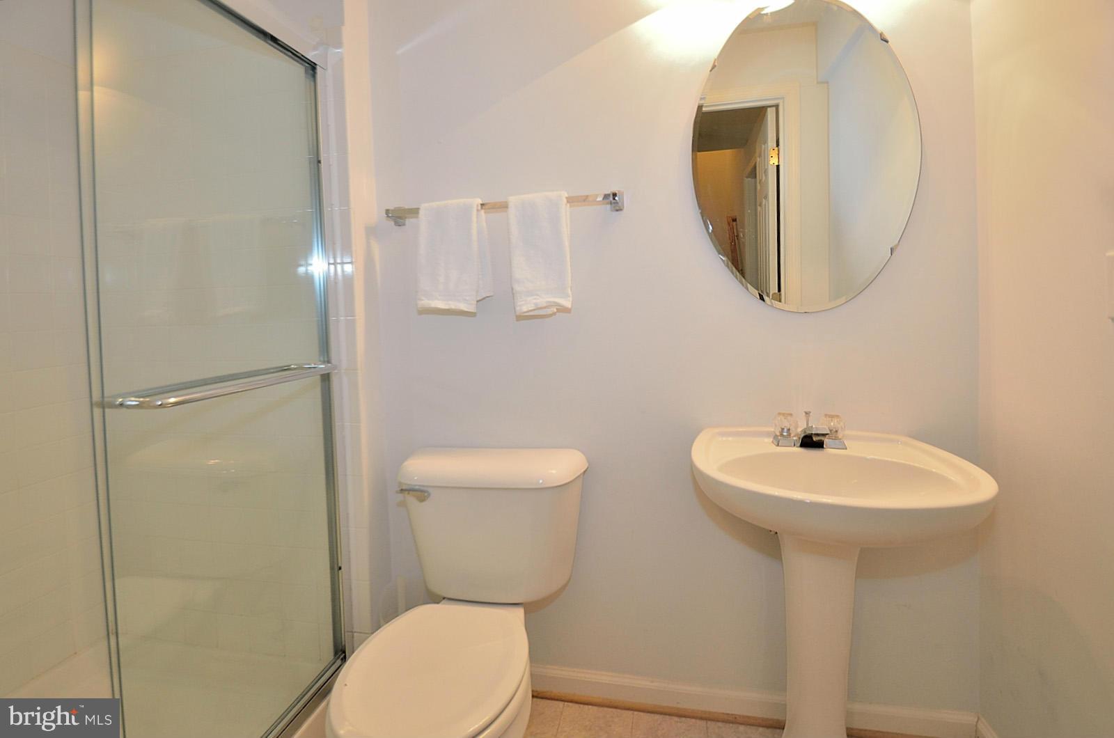 19933 Ridgecrest Square Ashburn, VA 20147 - Photo 13 of 19 a bathroom with a sink a mirror and a toilet