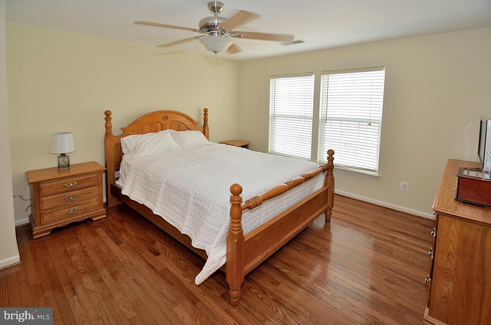 19933 Ridgecrest Square Ashburn, VA 20147 - Photo 14 of 19 a bed sitting in a bedroom next to a window