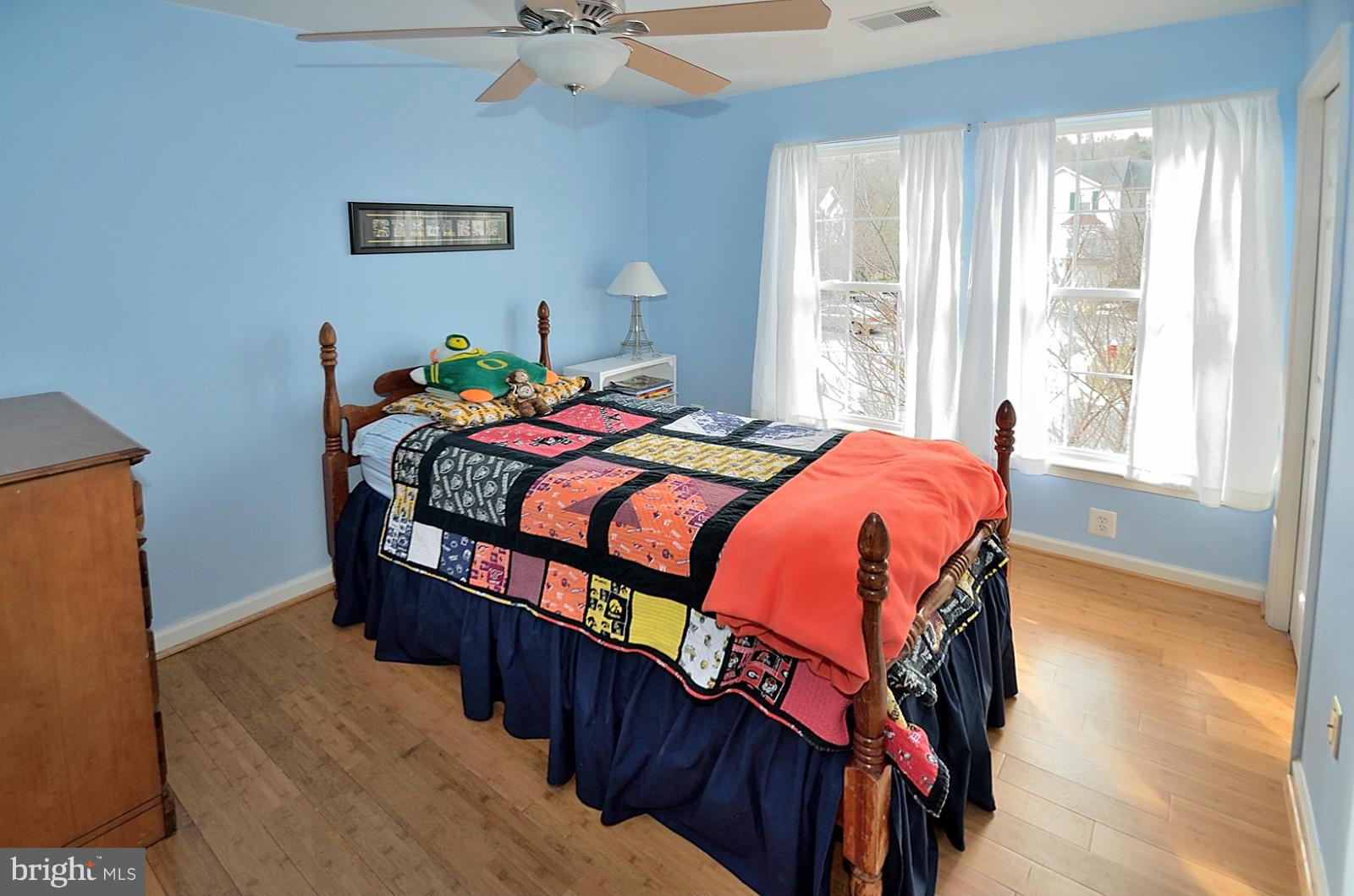 19933 Ridgecrest Square Ashburn, VA 20147 - Photo 15 of 19 a bedroom with a bed a window and a chandelier
