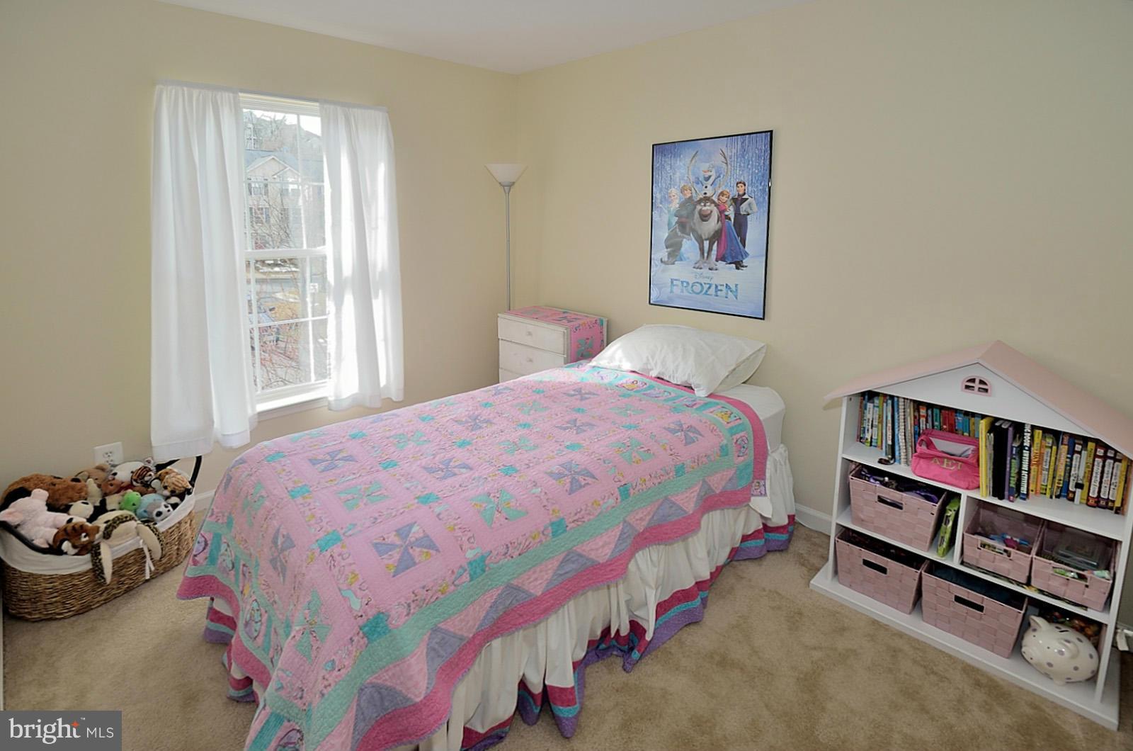 19933 Ridgecrest Square Ashburn, VA 20147 - Photo 16 of 19 a bedroom with a bed and a book shelf