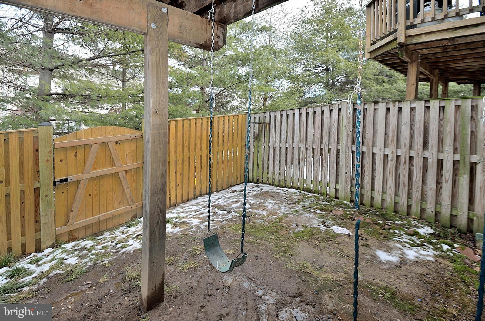 19933 Ridgecrest Square Ashburn, VA 20147 - Photo 19 of 19 a backyard of a house with wooden floor