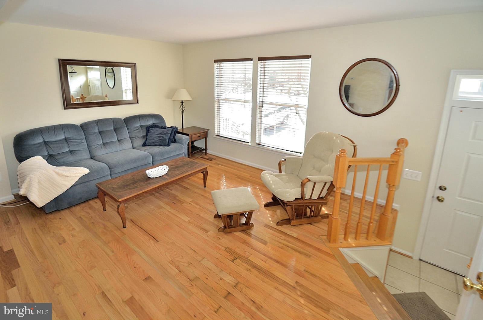 19933 Ridgecrest Square Ashburn, VA 20147 - Photo 7 of 19 a living room with furniture and wooden floor