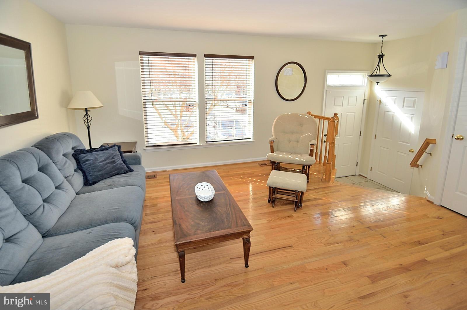 19933 Ridgecrest Square Ashburn, VA 20147 - Photo 8 of 19 a living room with furniture a clock and a window