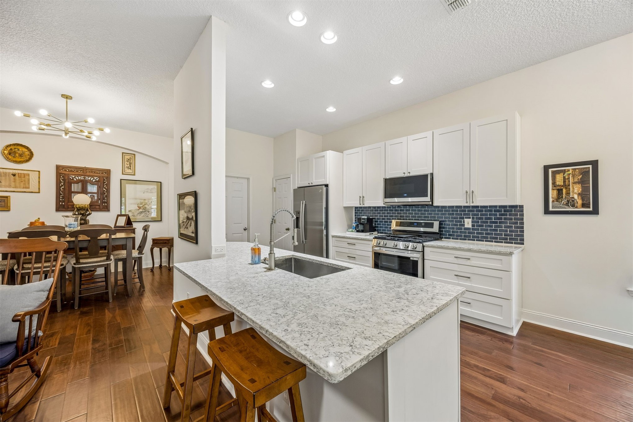 86107 Remsenburg Drive Fernandina Beach, FL 32034 - Photo 9 of 58 a kitchen with granite countertop kitchen island wooden floor center island and stainless steel appliances